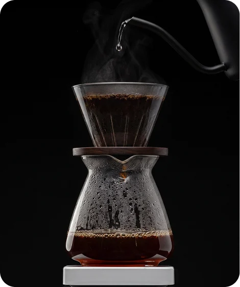 Pour-over coffee brewing in a glass carafe
