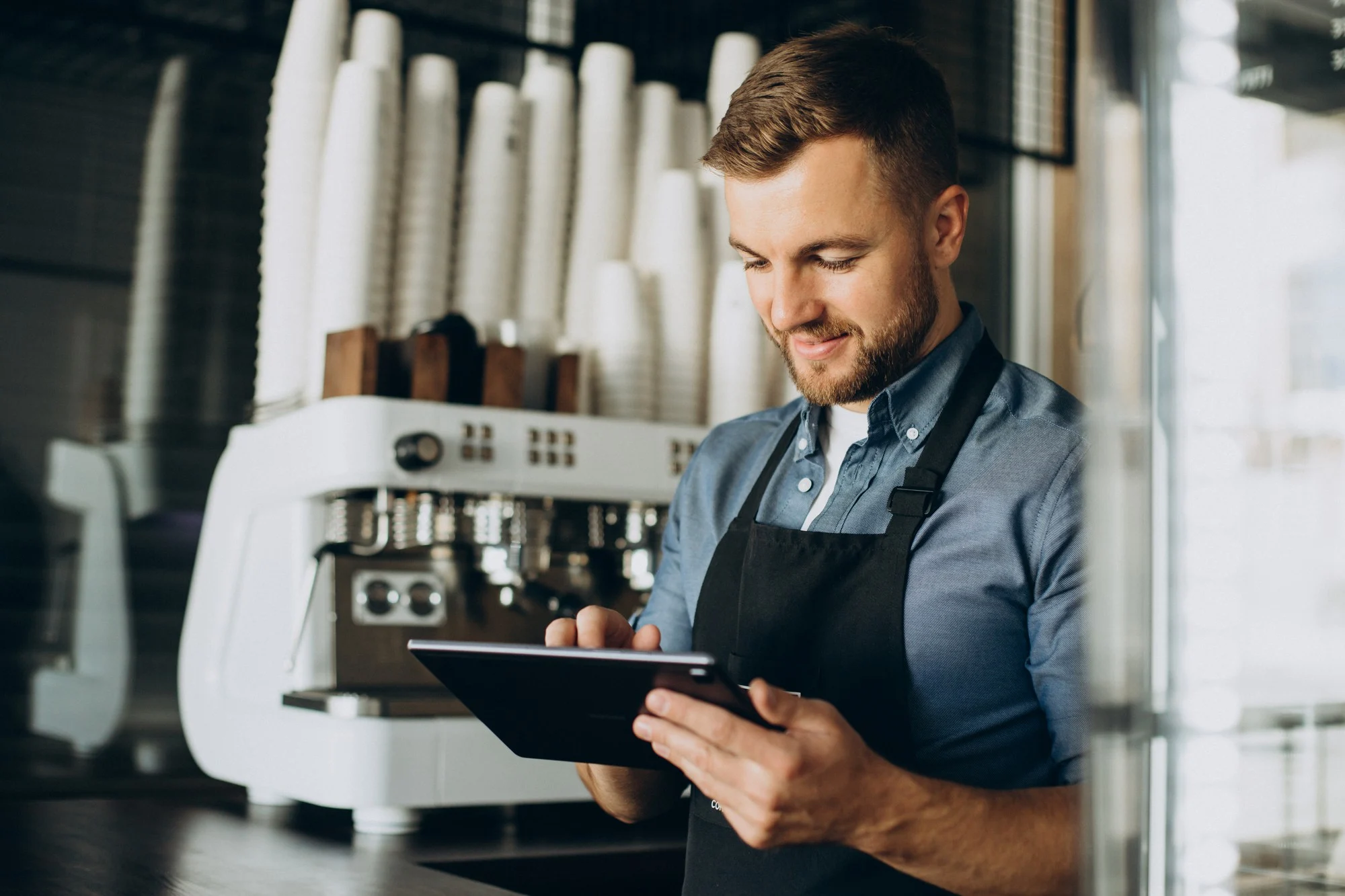 Cafe operator reviewing BrewMetrics data on a tablet